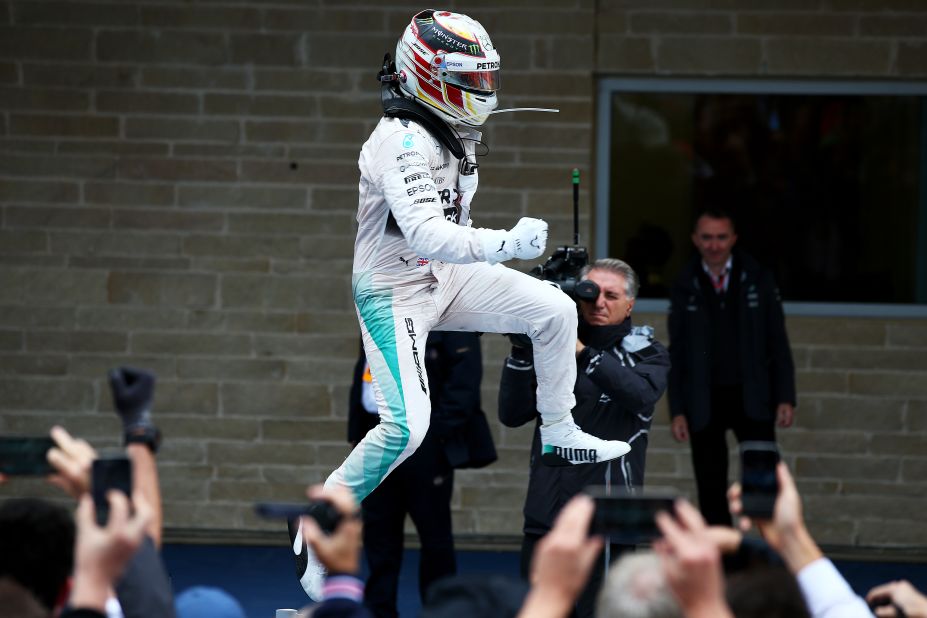 Lewis Hamilton jumps for joy after taking his third world title.