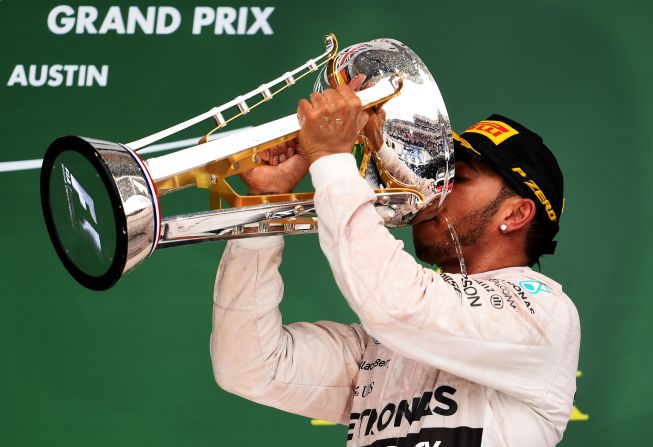 Champagne moment: Hamilton laps up his title success in Austin after winning the United States Grand Prix. 