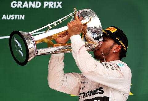 Champagne moment: Lewis Hamilton laps up his third world title success in Austin after winning the United States Grand Prix for his 10th win of the season