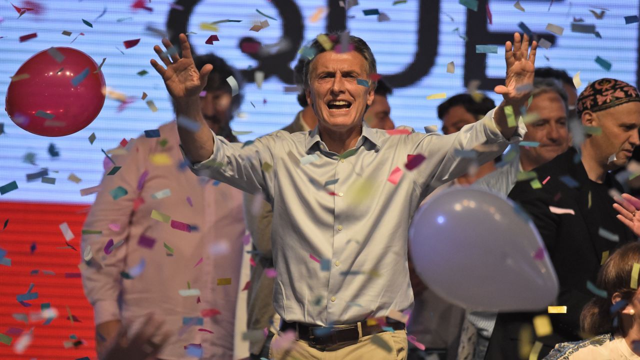 Argentine presidential candidate Mauricio Macri gestures at supporters at the party's headquarters in Buenos Aires on October 25, 2015. Buenos Aires Governor Daniel Scioli led Argentina's presidential election race as counting got under way Sunday, but it was unclear whether he would avoid a runoff against his conservative rival Mauricio Macri.  AFP PHOTO / EITAN ABRAMOVICH        (Photo credit should read EITAN ABRAMOVICH/AFP/Getty Images)