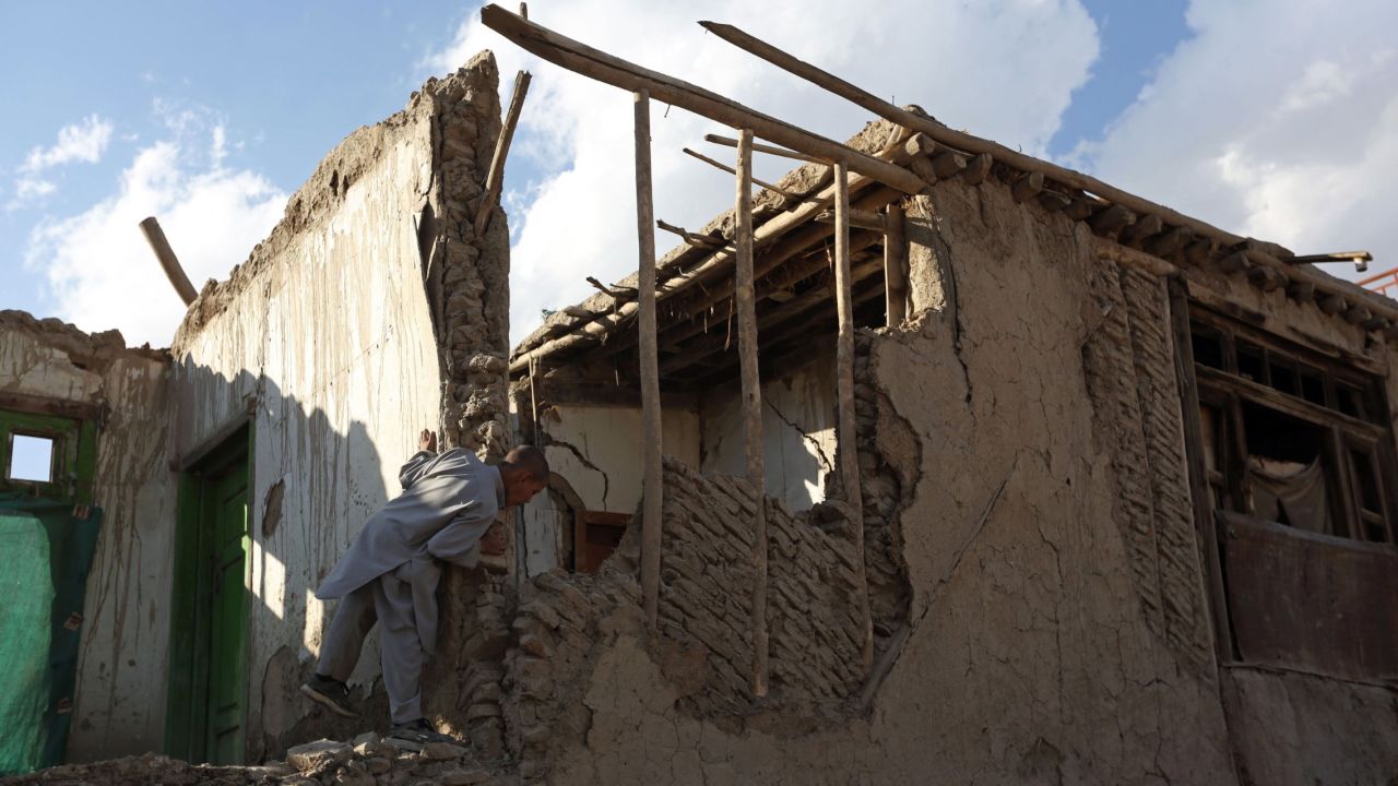 A boy looks at a damaged house in Kabul, Afghanistan.