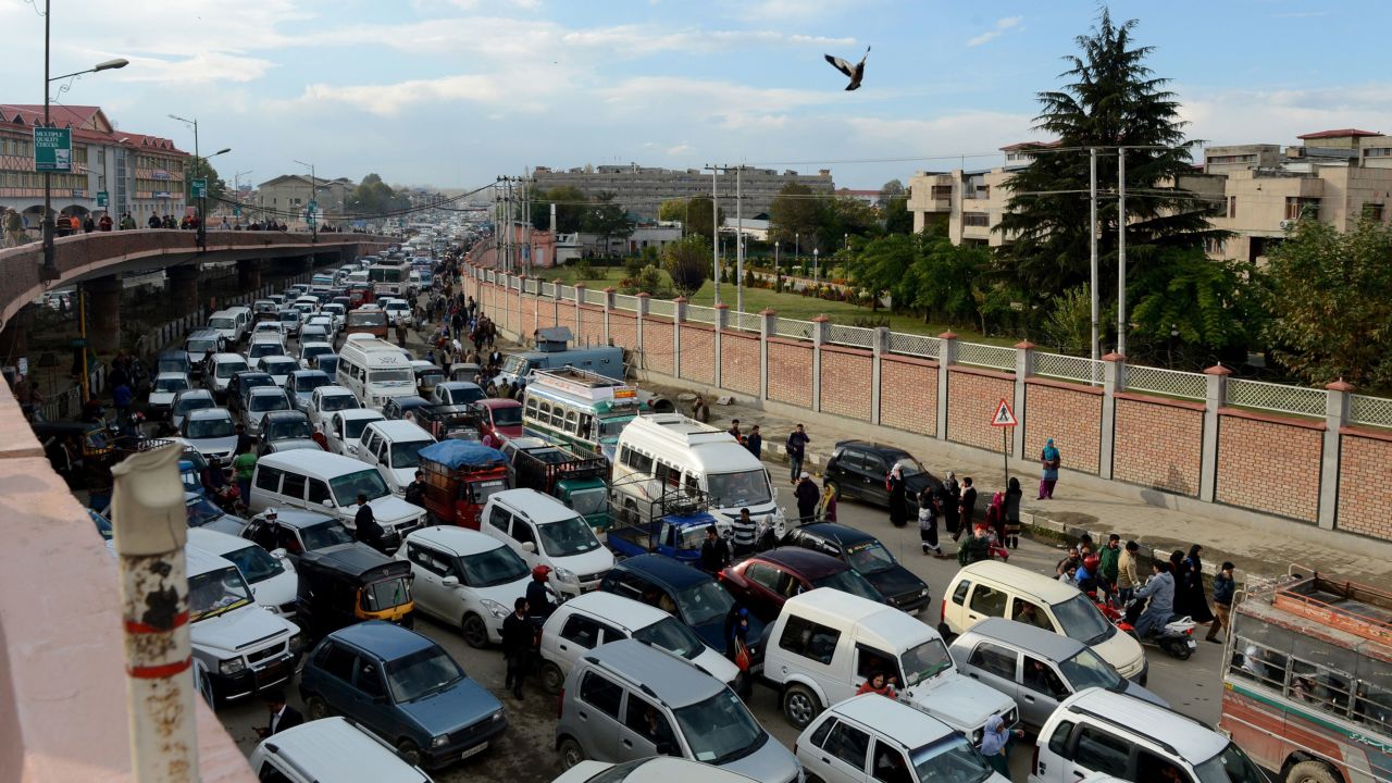 Stranded drivers wait in and around their vehicles in Srinagar, India, on October 26.