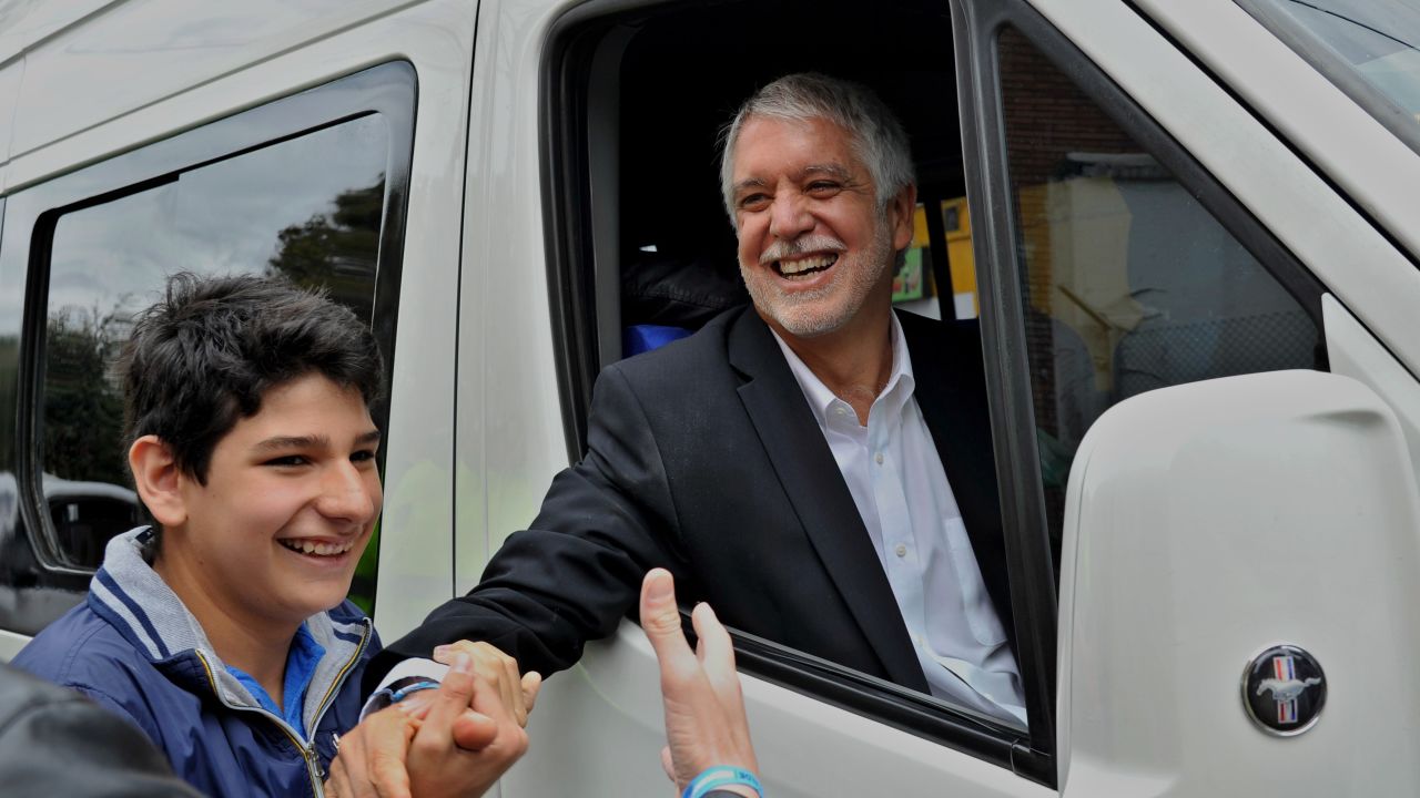 Bogota's Mayor Candidate Enrique Penalosa greets supporters after casting his vote on October 25, 2015. Colombians went to the polls Sunday to elect provincial governors and hundreds of local officials who will have a crucial role in implementing any peace agreement reached with leftist FARC rebels. AFP PHOTO / GUILLERMO LEGARIA        (Photo credit should read GUILLERMO LEGARIA/AFP/Getty Images)