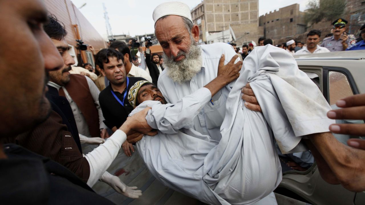 A man is carried to a hospital in Peshawar on Monday, October 26.