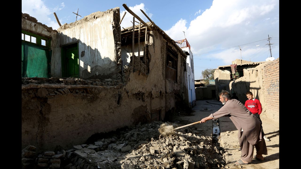 A man clears rubble from a damaged house in Kabul, Afghanistan.