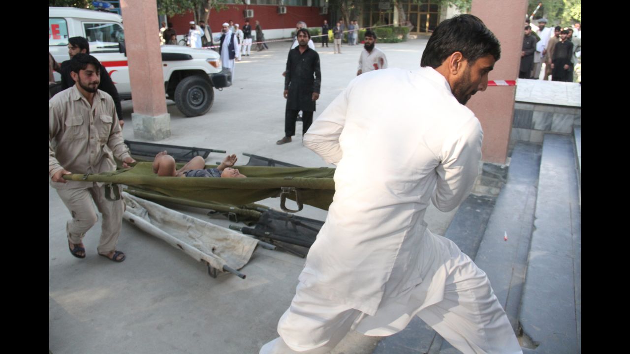 People transfer an injured child to a hospital in Jalalabad, Afghanistan.