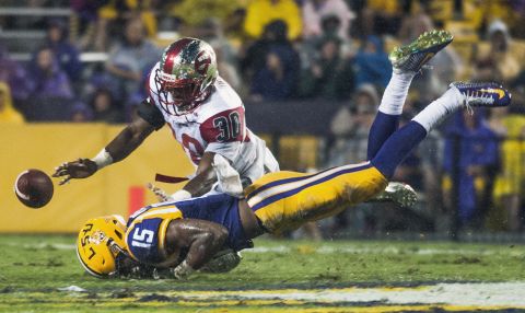 Western Kentucky defensive back Prince Charles Iworah, top, and LSU Tigers wide receiver Malachi Dupre dive for a pass that fell incomplete during an NCAA college football game on Saturday, October 24, in Baton Rouge, Louisiana.  