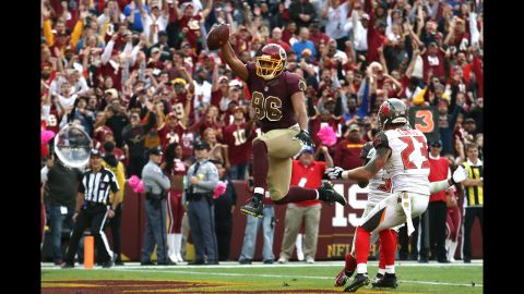 Tight end Jordan Reed of the Washington Redskins scores a fourth quarter touchdown past strong safety Chris Conte of the Tampa Bay Buccaneers during a game on Sunday, October 25, in Landover, Maryland.