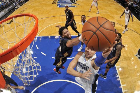 Nikola Vucevic, right, of the Orlando Magic shoots the ball against Anthony Davis of the New Orleans Pelicans during a preseason game on Wednesday, October 21, at Amway Center in Orlando, Florida.  