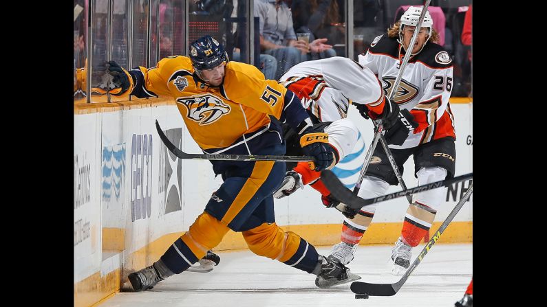 Austin Watson, left, of the Nashville Predators checks Ryan Getzlaf of the Anaheim Ducks during an NHL game at Bridgestone Arena on Thursday, October 22, in Nashville, Tennessee. 