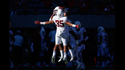 Hunter Dale of the Washington State Cougars celebrates with teammate Taylor Taliulu after a fourth down stop against the Arizona Wildcats during the fourth quarter on Saturday, October 24, in Tucson, Arizona. The Cougars defeated the Wildcats 45-42.