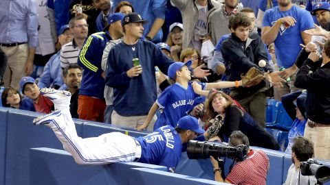 Toronto Blue Jays first baseman Chris Colabello attempts to catch a foul ball during the third inning in Game 5 of the American League Championship Series against the Kansas City Royals on Wednesday, October, 21, in Toronto.  