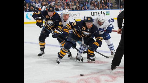 From left, Nicolas Deslauriers and Zemgus Girgensons of the Buffalo Sabres battle for the puck against Leop Komarov and Nazem Kadri of the Toronto Maple Leafs during a National Hockey League game on Wednesday, October 22.  