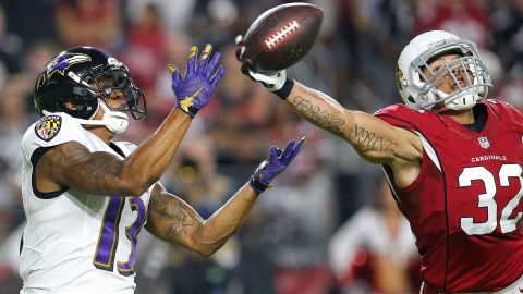Tyrann Mathieu of the Arizona Cardinals knocks away the ball from Baltimore Ravens wide receiver Chris Givens in Glendale, Arizona, on Monday, October 26.