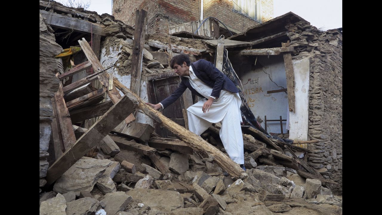 A man sifts through the rubble of a house in Mingora, Pakistan, on Tuesday, October 27. A magnitude-7.5 earthquake struck near Jarm, Afghanistan, along the Afghanistan-Pakistan border, on Monday.