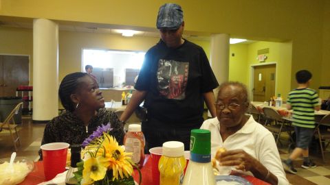 Pamela Burrell greets diners enjoying a meal from Action Ministries.