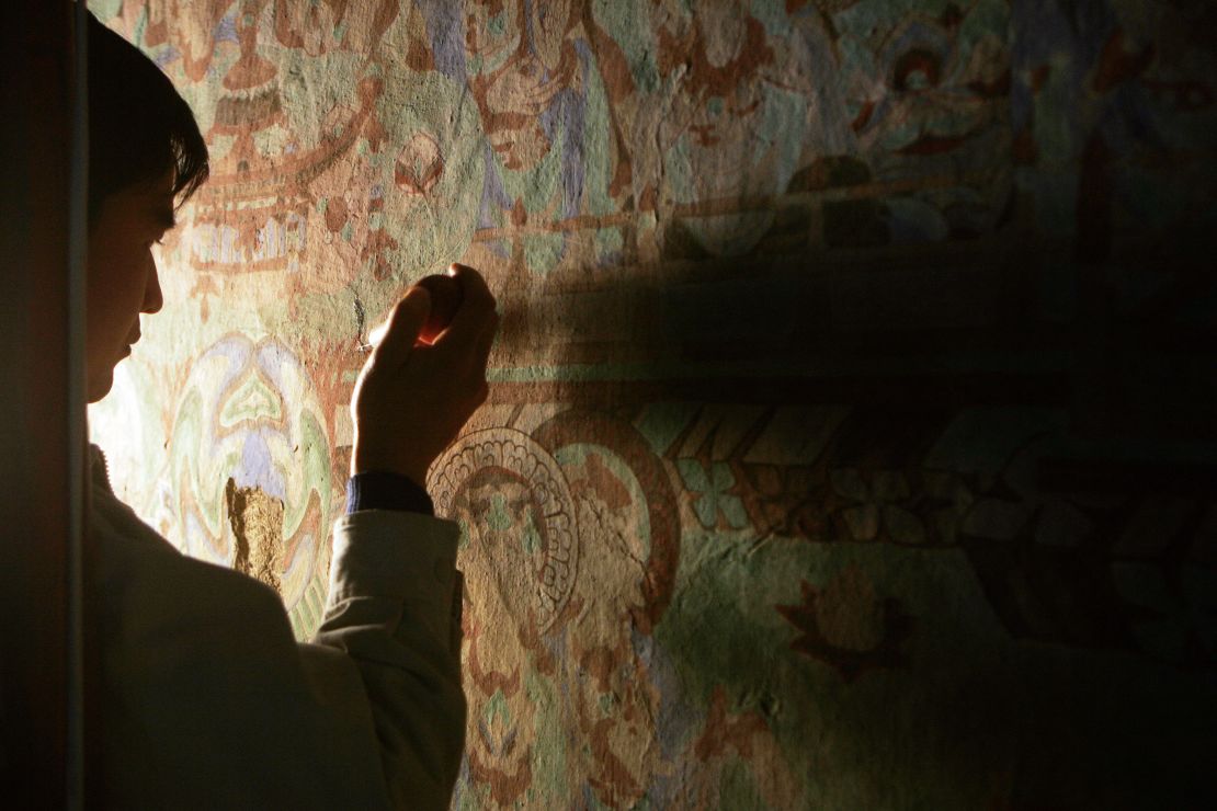 The Mogao Grottoes in Dunhuang house some of the greatest collections of Buddhist art, the cave frescoes were created beginning 1,650 years ago as eternal tributes to Buddha but are today fading away from age, tourist pressures and climate change.