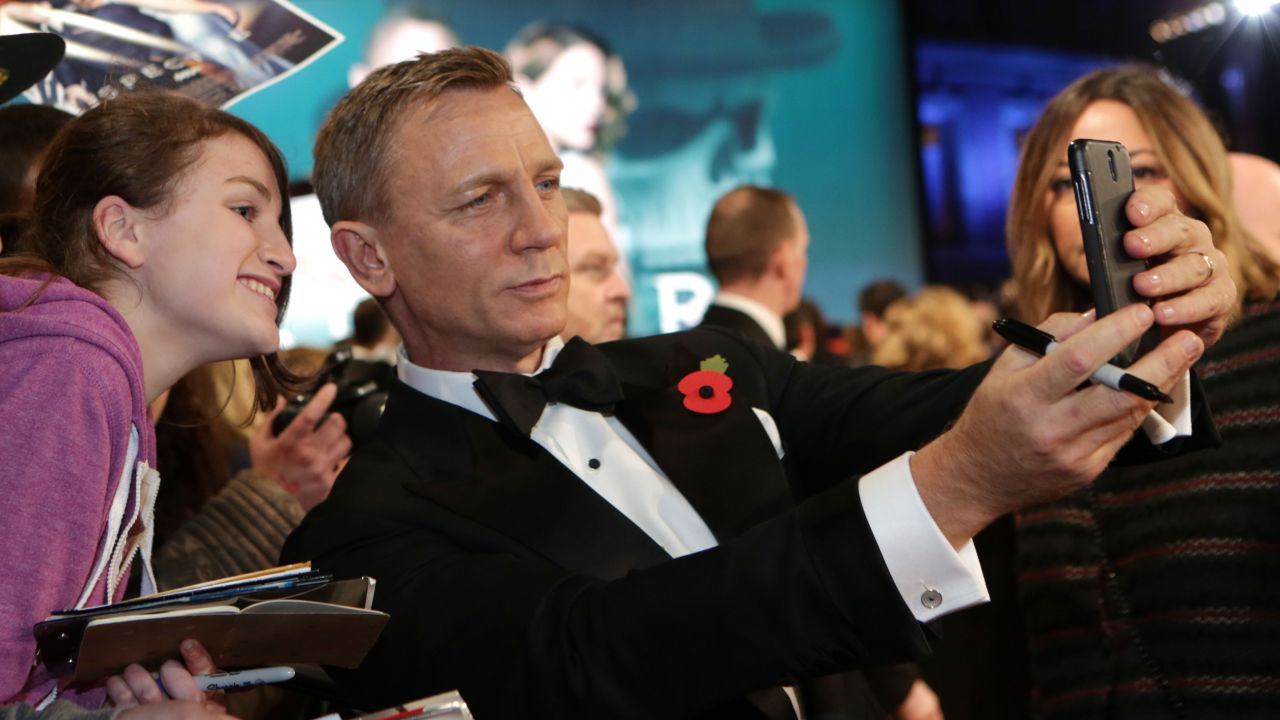 Daniel Craig takes a selfie with a fan at the James Bond "Spectre" premiere in London on Monday, October 26.