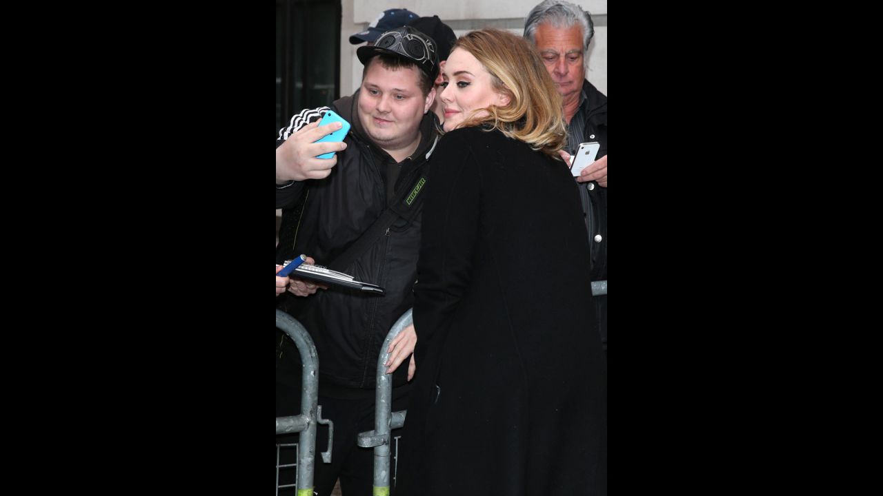 Adele takes a selfie with a fan in London on Friday, October 23, the same day the song "Hello" from her upcoming album was released.