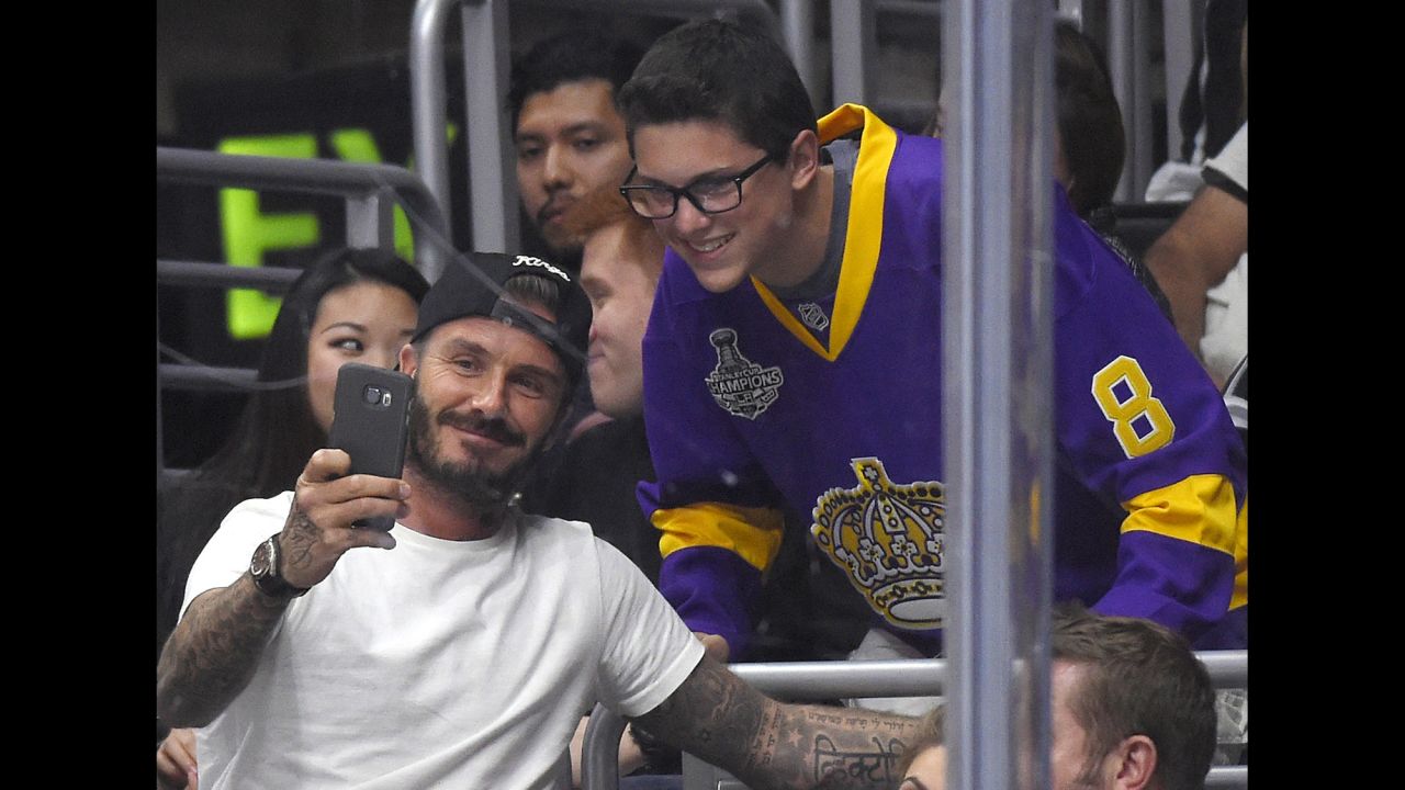 David Beckham and a fan take a selfie while attending a NHL game in Los Angeles on Friday, October 23. The Los Angeles Kings beat the Carolina Hurricanes 3-0.