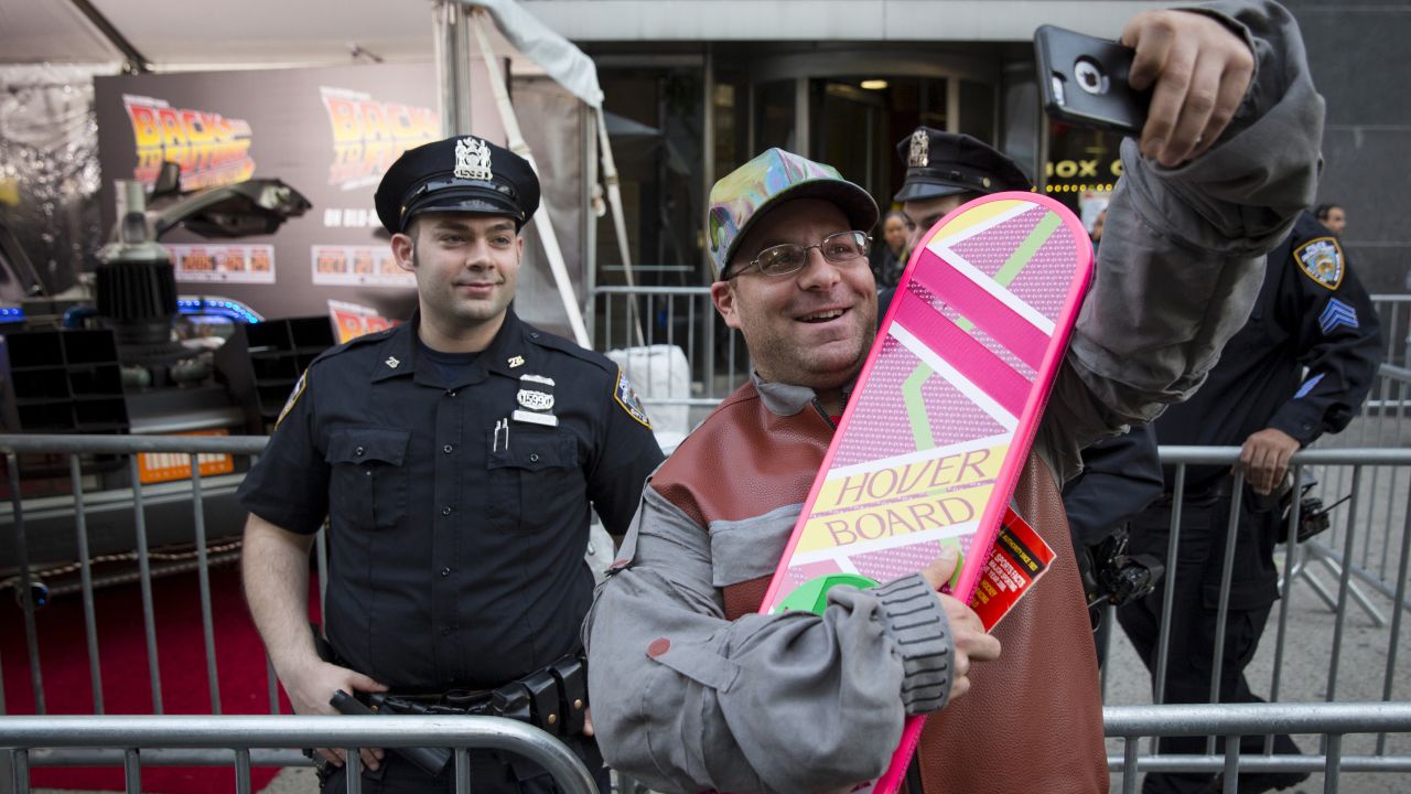 Michael Sciaraffo of Brooklyn, dressed as Marty McFly, takes a selfie in front of the DeLorean parked outside the "Back to the Future" 30th anniversary screening in New York on Wednesday, October 21.