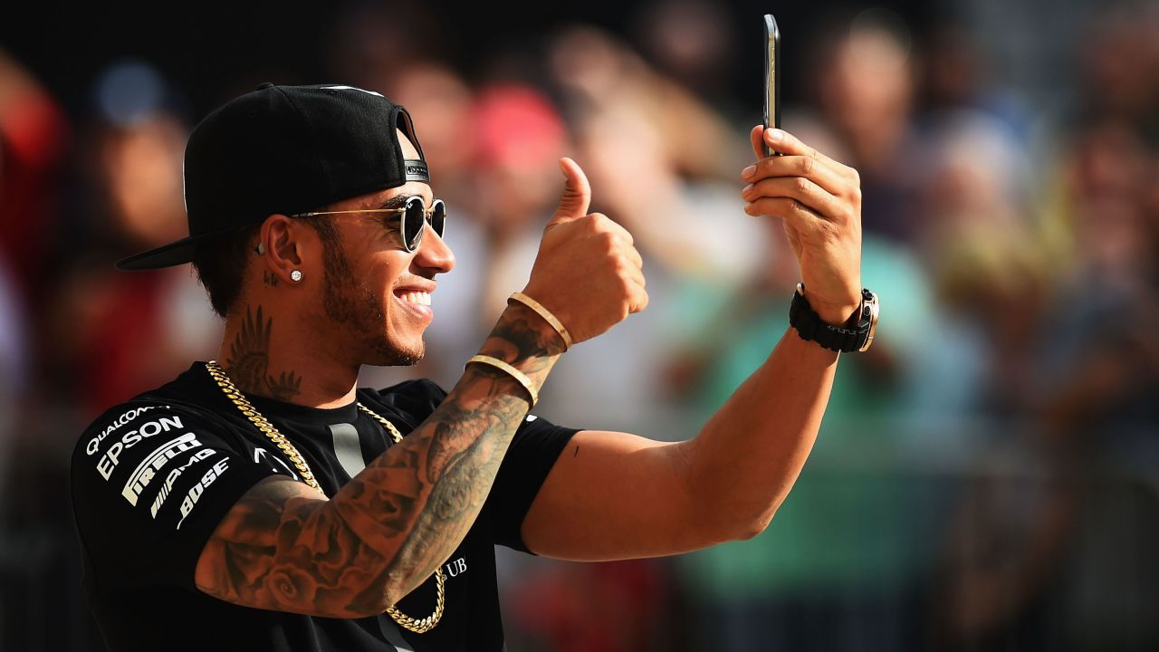 Lewis Hamilton takes a selfie in the pit lane after an autograph session during previews to the United States Formula One Grand Prix in Austin, Texas, on Thursday, October 22.