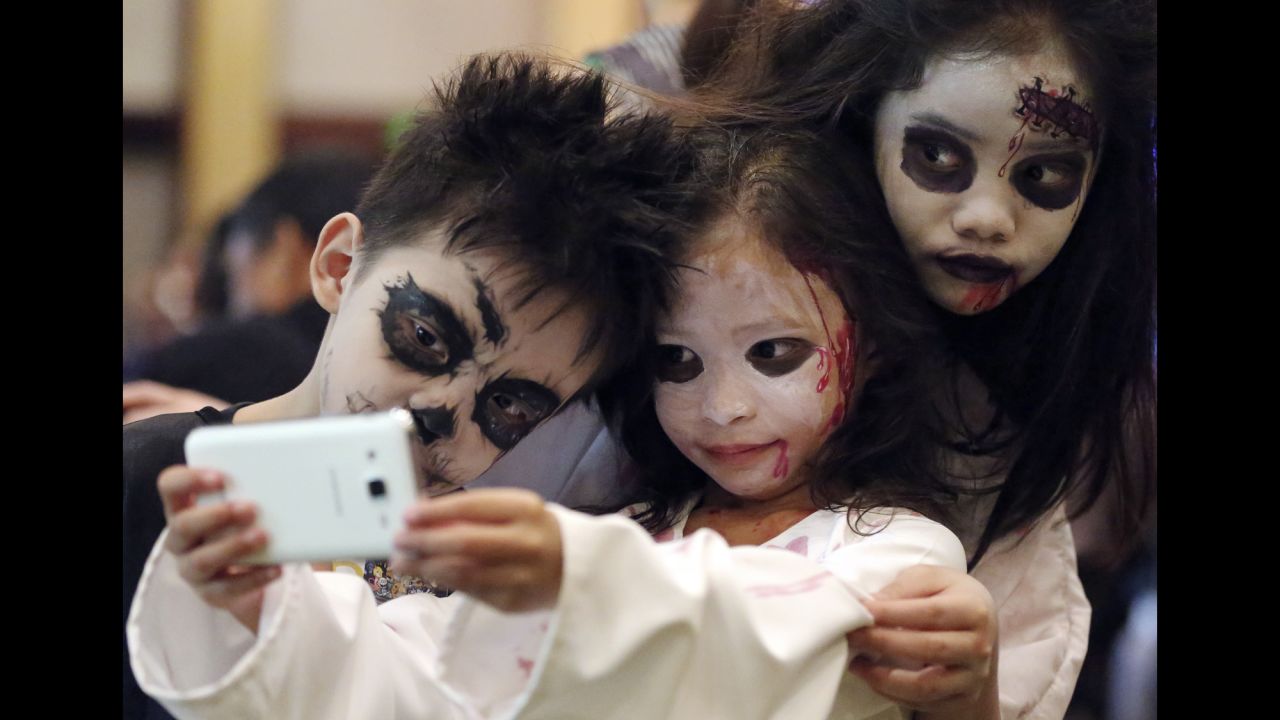 Filipino children pose for a selfie during a Halloween event in Manila on Sunday, October 25.