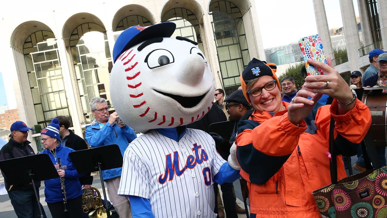 A New York Mets fan takes a selfie with Mr. Met during the Met Opera And Mr. Met performance of "Meet the Mets" in New York on Tuesday, October 27.