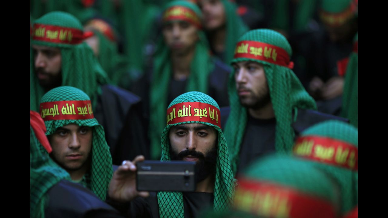 A Lebanese Shiite supporter of Hezbollah takes a selfie during the holy day of Ashura in southern Beirut, Lebanon, on Saturday, October 24.