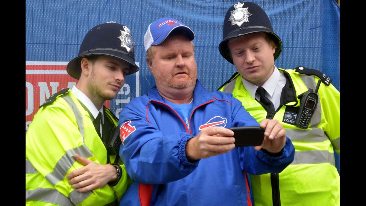 A Buffalo Bills fan poses for a selfie with Metropolitan Police in London on Saturday, October 24, before the International Series NFL game between the Bills and the Jacksonville Jaguars.