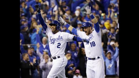 Royals shortshop Alcides Escobar, left, celebrates with teammate Ben Zobrist after hitting an inside-the-park home run on the first pitch of the game.