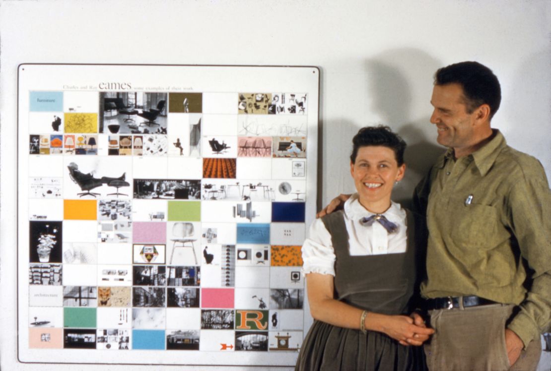 Charles and Ray Eames with a panel of Eames Office work made for the American Institute of Architects, 1957.