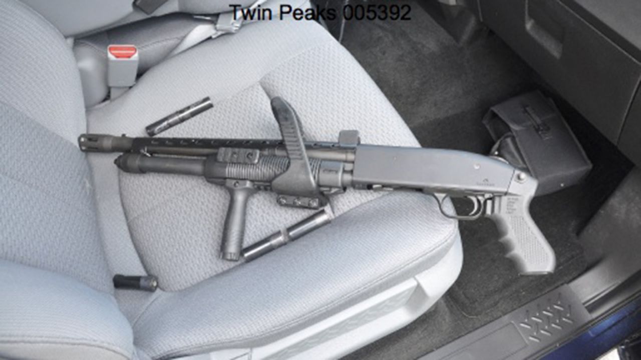A gun is seen in the passenger seat of a car. 