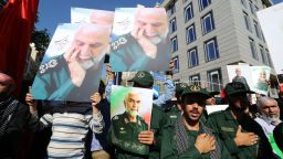 A picture taken on October 11, 2015 shows Iranian men, including members of the Iranian revolutionary guard, holding portraits during the funeral procession of Iran's Revolutionary Guards Brigadier General Hossein Hamedani in Tehran. Many Iranians have died in Syria since early October 2015, a sign of Irans commitment, along with Russia, to support the regime of Syrian President Bashar al-Assad.