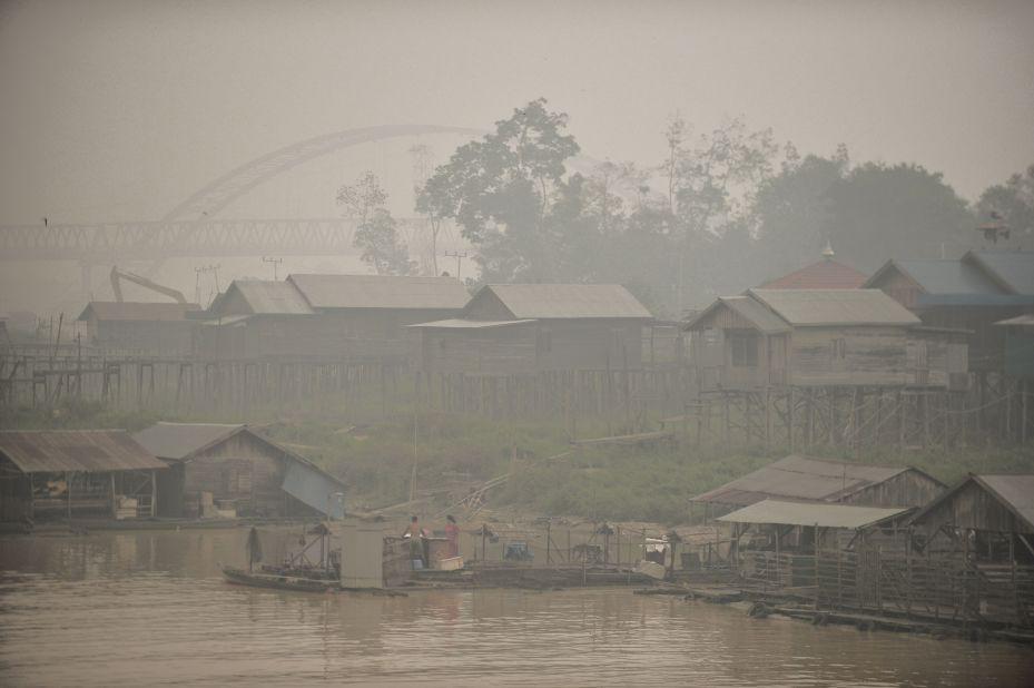 Residents by the Kahayan riverbanks go about their daily lives in haze-hit Palangkaraya on October 25.