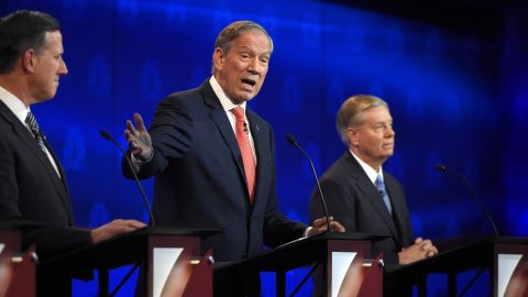 Former New York Gov. George Pataki, center, also went after the Democrats. He said Hillary Clinton's private email server as secretary of state "disqualifies" her from being president.
