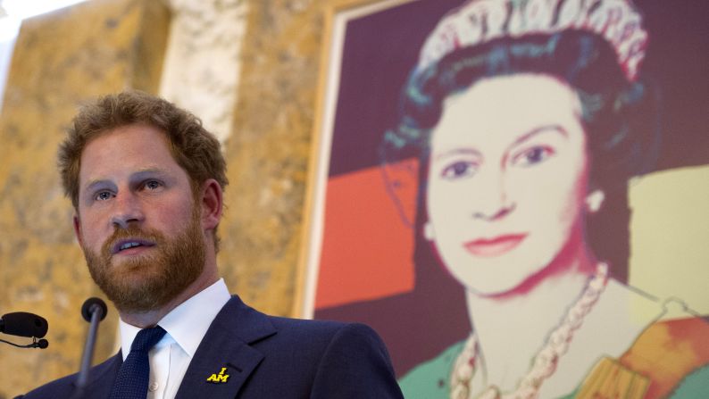 An Andy Warhol screenprint of Queen Elizabeth II looks down on Britain's Prince Harry while he speaks at an Invictus Games reception at the British Ambassador's Residence in Washington, on Wednesday, October 28. Prince Harry is on a one-day visit to the Washington, D.C., area.