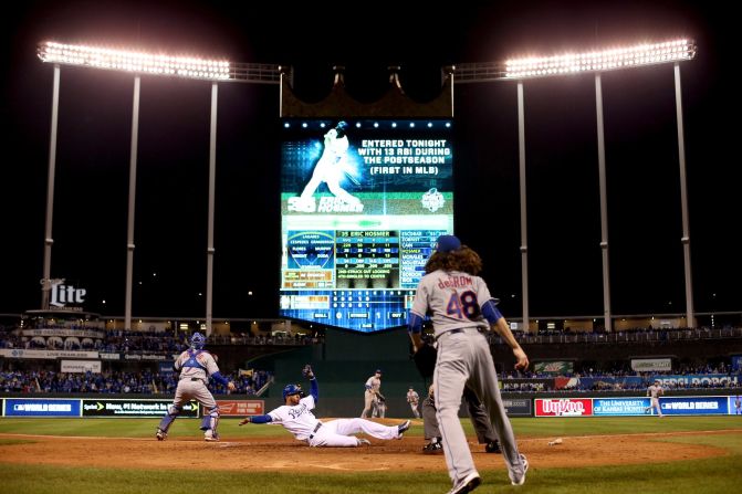 Alcides Escobar of the Royals scores a run on a two-run RBI single hit by teammate Eric Hosmer.