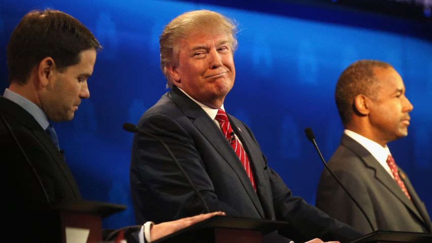 BOULDER, CO - OCTOBER 28:  Presidential candidate Donald Trump (C) smiles while Sen. Marco Rubio (L)   and Ben Carson look on during the CNBC Republican Presidential Debate at University of Colorados Coors Events Center October 28, 2015 in Boulder, Colorado.  Fourteen Republican presidential candidates are participating in the third set of Republican presidential debates.  (Photo by Justin Sullivan/Getty Images)