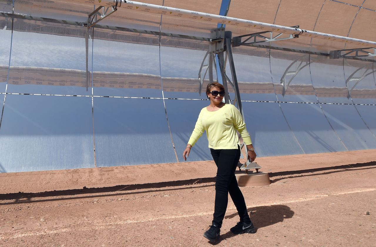 Morocco's environment minister Hakima El Haite walks in front of a solar array that is part of the Noor 1 solar power plant, which is due to  start operating in a few weeks. 