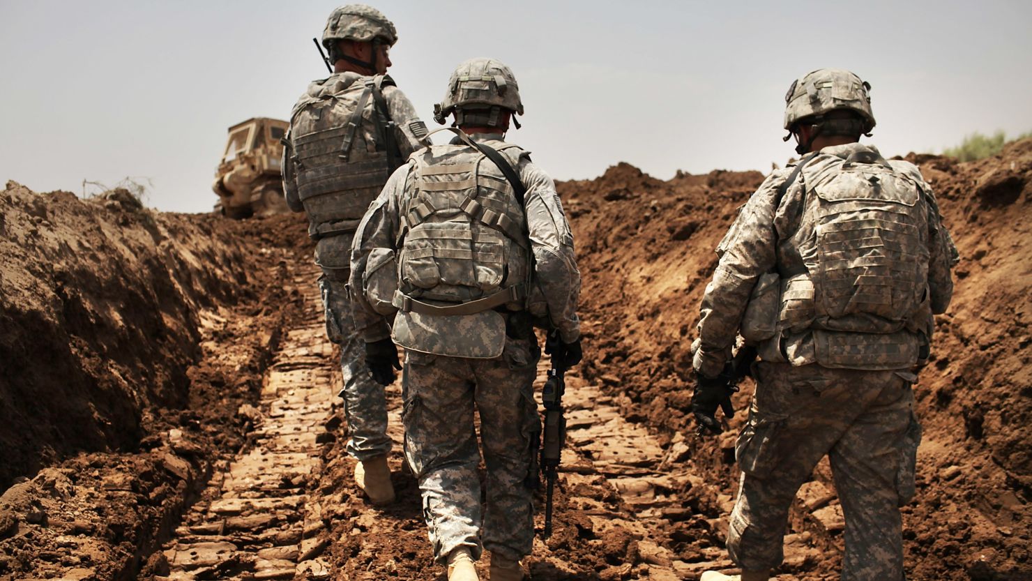 ISKANDARIYA, IRAQ - JULY 19: U.S. soldiers with the 3rd Armored Cavalry Regiment patrol a new ditch they have dug to protect the base from attack on July 19, 2011 in Iskandariya, Babil Province Iraq. As the deadline for the departure of the remaining American forces in Iraq approaches, Iraqi politicians have agreed to meet in two weeks time in order to give a final decision about extending the U.S. troops' presence beyond the end of the 2011 deadline. Violence against foreign troops has recently picked-up with June being the worst month in combat-related deaths for the military in Iraq in more than two years. Currently about 46,000 U.S. soldiers remain in Iraq.  (Photo by Spencer Platt/Getty Images)