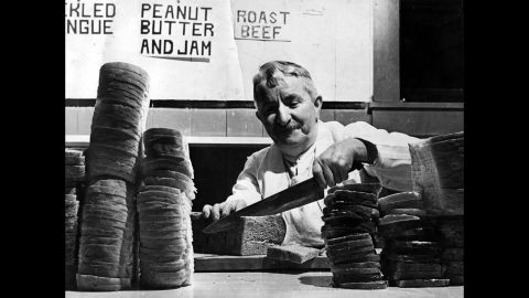 Englishman Harry Hawkins prepares peanut butter and jam sandwiches for lumberjacks in the Canadian Rockies in 1941.