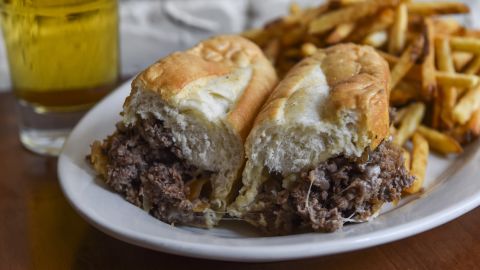 The classic Philly cheesesteak contains melted Provolone over thinly sliced grilled steak on a long hoagie roll. When in Philadelphia visit Pat's or Geno's for an authentic, and greasy, taste of history.