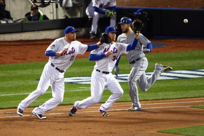 The Royals' Eric Hosmer is safe at first as the Mets' Noah Syndergaard, center, and Lucas Duda fail to make a play.