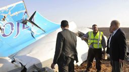 In this image released by the Prime Minister's office, Sherif Ismail, right, looks at the remains of a crashed passenger jet in Hassana Egypt, Friday, Oct. 31. A Russian aircraft carrying 224 people, including 17 children, crashed Saturday in a remote mountainous region in the Sinai Peninsula about 20 minutes after taking off from a Red Sea resort popular with Russian tourists, the Egyptian government said. There were no survivors.