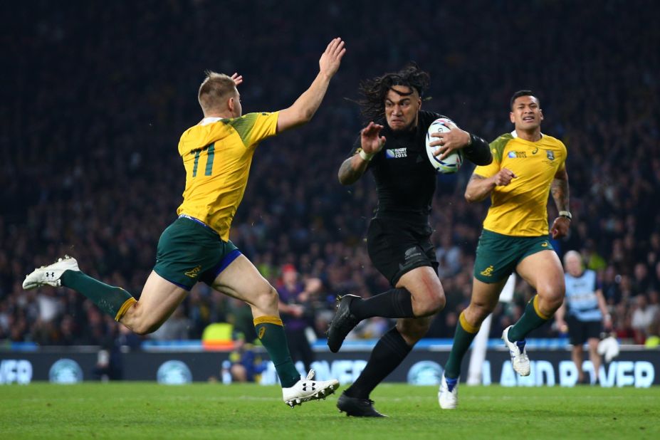 Ma'a Nonu of New Zealand hands off Drew Mitchell of Australia on the way to score his team's second try of the final early in the second half.