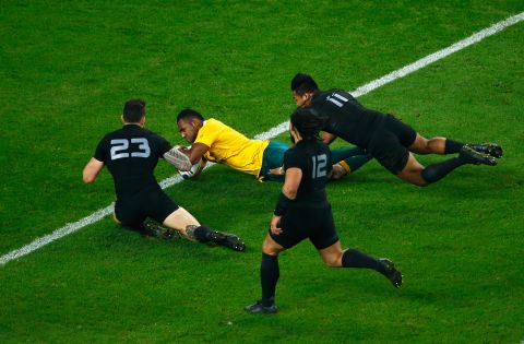 Tevita Kuridrani holds off Sonny Bill Williams and Savea to dive over for Australia's second try in a second half fightback, which was eventually in vain.