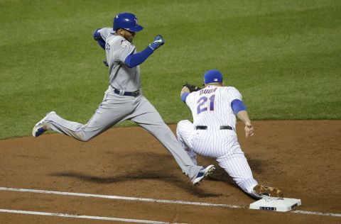 The Royals' Alcides Escobar is out at first as the Mets' Lucas Duda takes the throw during the third inning.