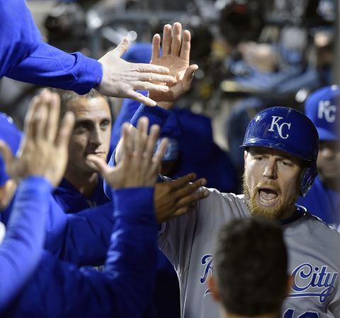 The Royals' Ben Zobrist celebrates in the dugout after scoring on an RBI single by Lorenzo Cain in the sixth inning.