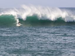 A surfer rides a wave at Waimea Bay October 28.